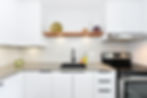 Modern flat panel kitchen with floating shelf