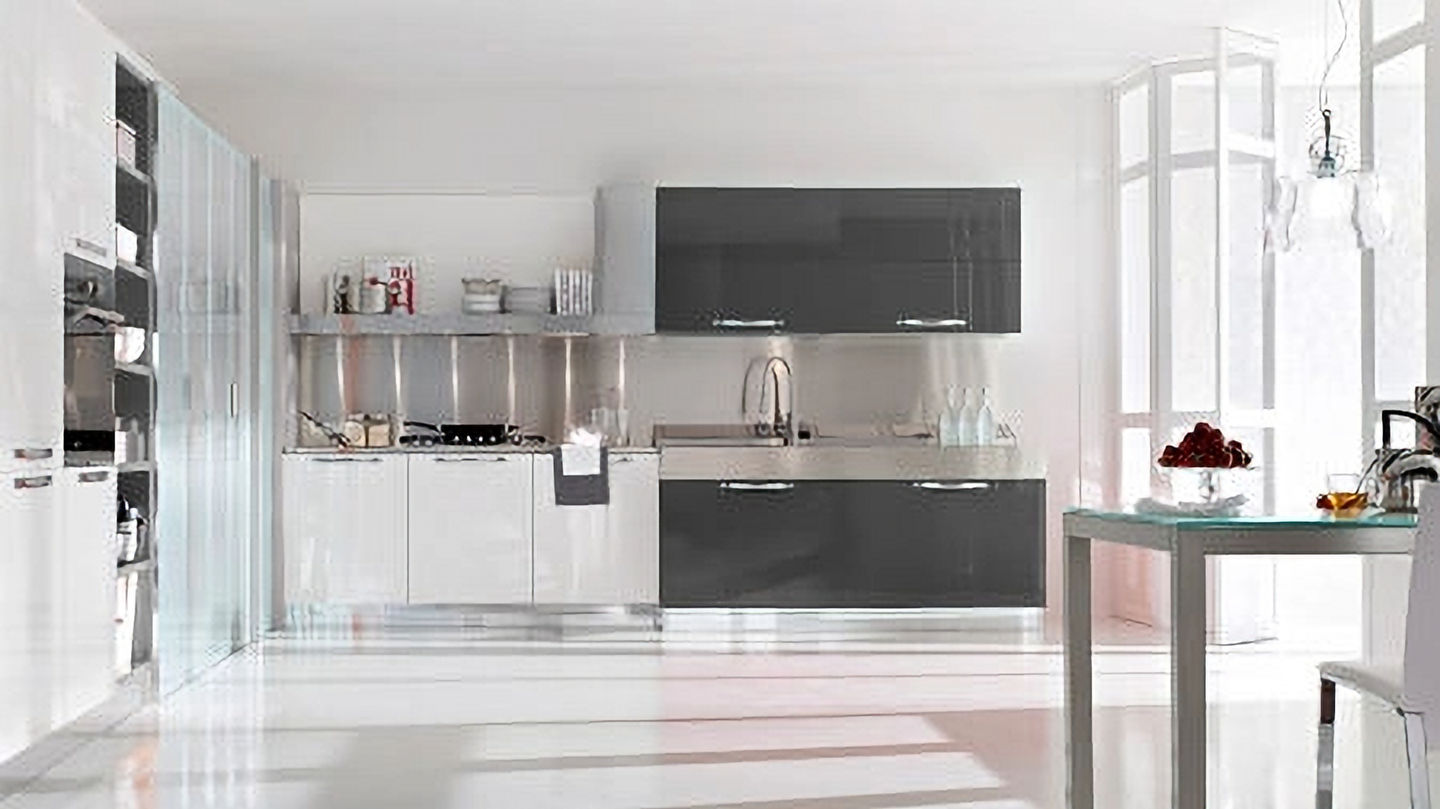 Modern kitchen with gray and white cabinets, stainless steel, and a table.