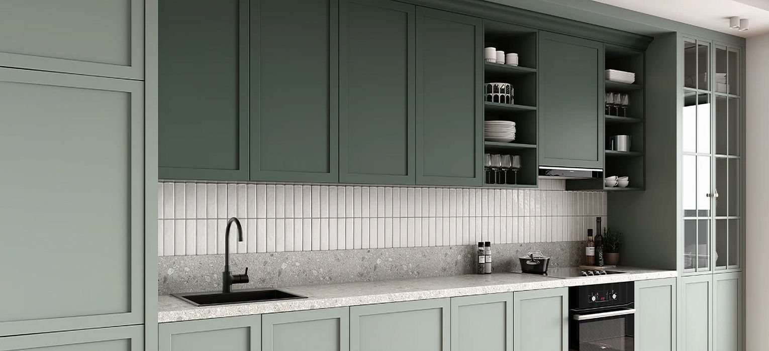 Green and gray kitchen cabinets with tile backsplash and black faucet.