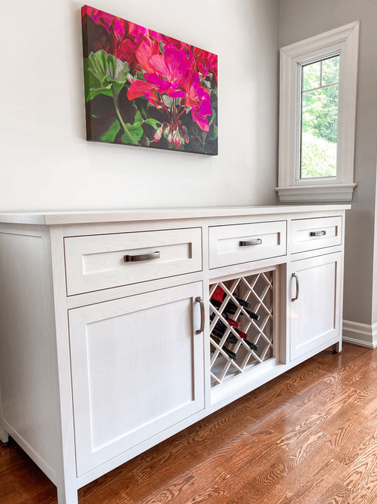 Inset door sideboard cabinet with wine rack, stained in white.