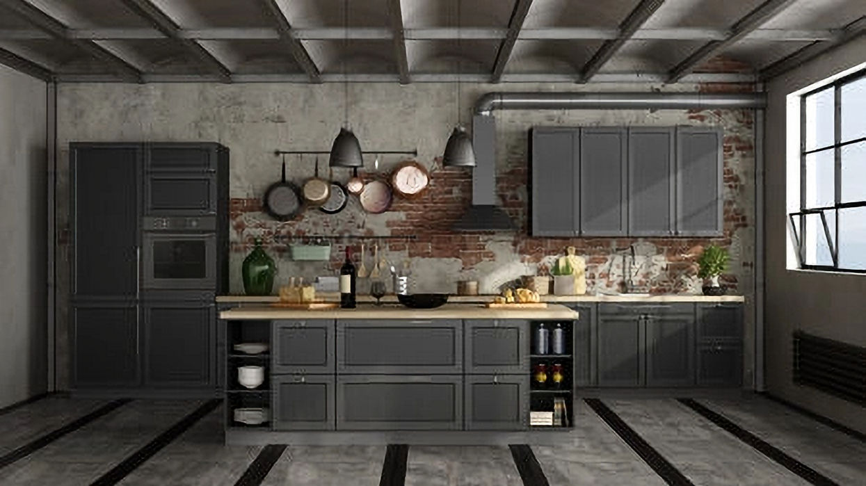 Industrial kitchen with dark gray cabinets and brick wall background.