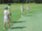 Young golfers practicing putting on a green at Klubs4Kids, a youth golf training program focused on skill development, confidence, and teamwork in a supportive environment.