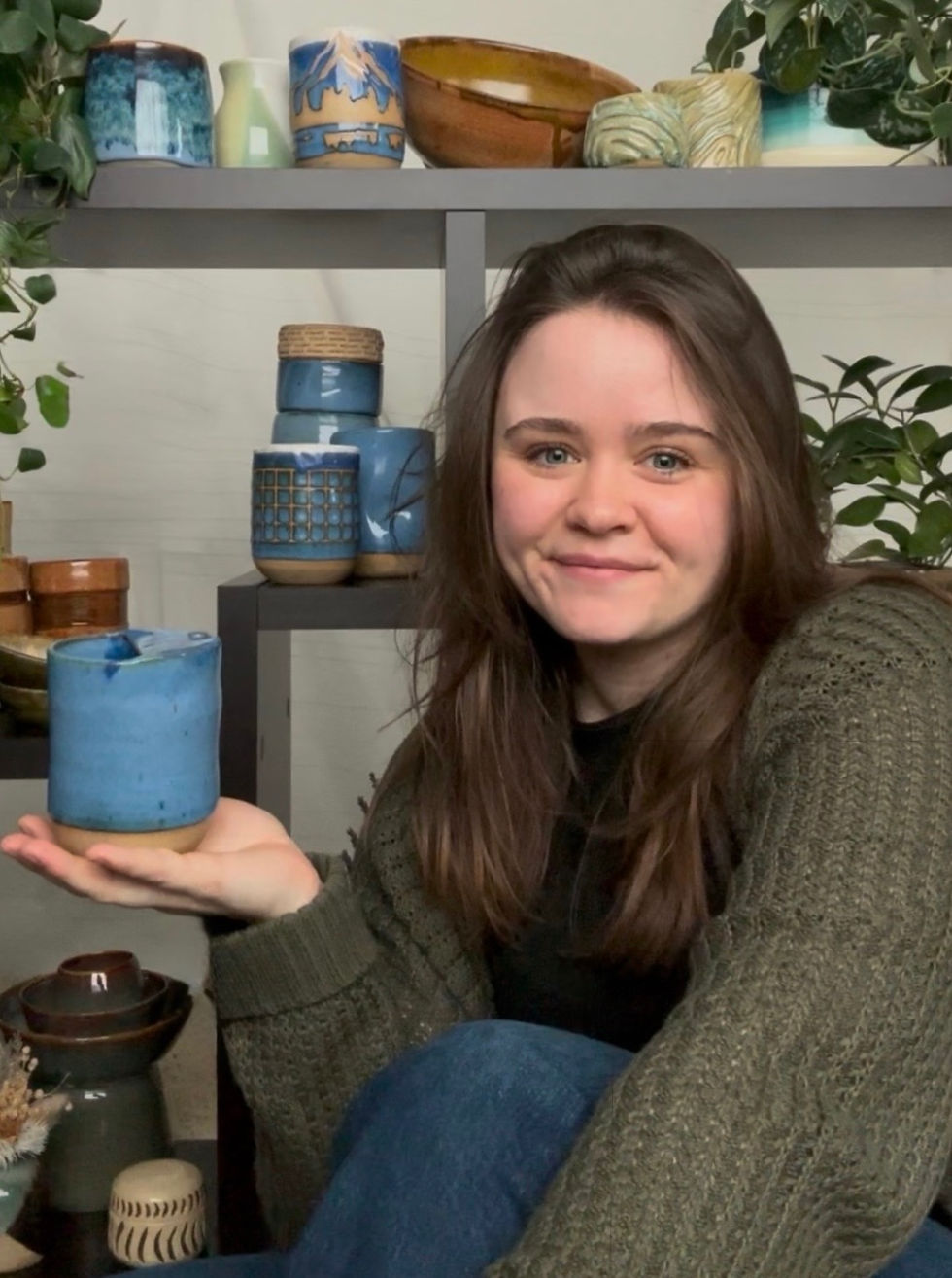 Woman displaying ceramic mug