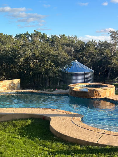 Rainwater harvesting system used for refilling a pool and collecting runoff from impervious surfaces in Austin, Texas