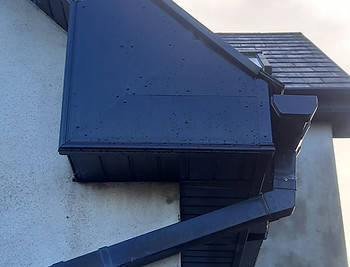 Dark blue rain gutters and fascia