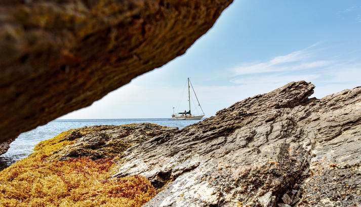 Rock slice with sailboat and ocean in the distance Santa Marta Tayrona Inca Inca