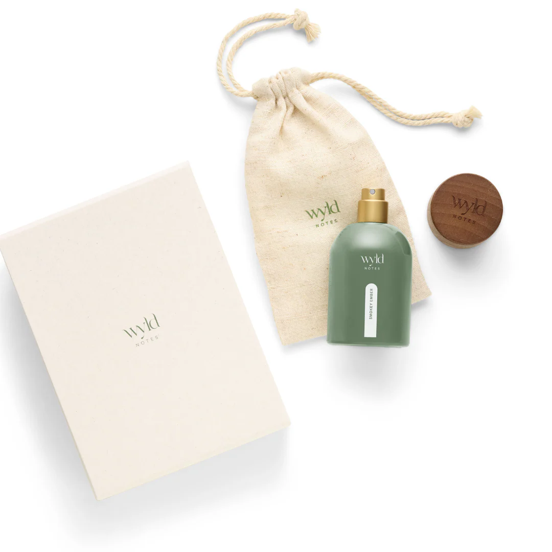 Green bottle and wooden lid labeled "Wyld Notes" with a beige pouch and box. Clean, minimalist design.