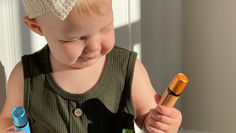 little girl holding essential oils