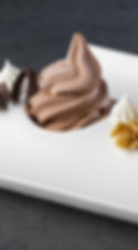 Chocolate soft serve on a white dish