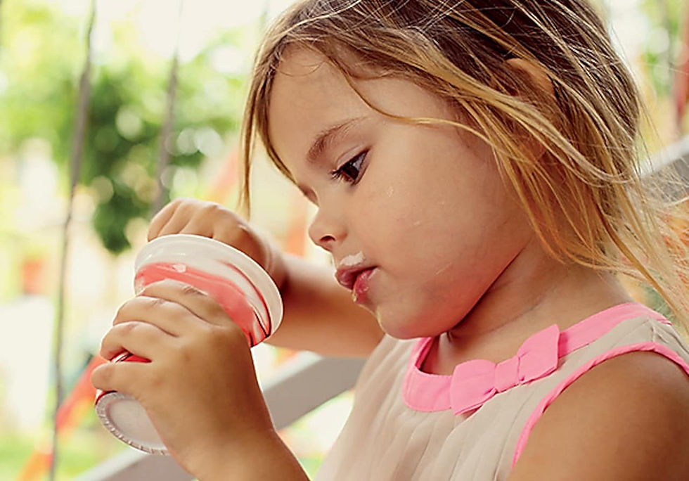 Young girl with soft serve in a cup