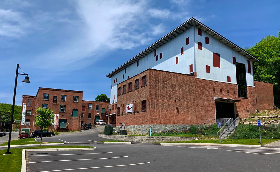 The mural lives in this old mill building on Whiting Street in Winsted. The roof had to be raised because the mural is five stories tall. Photo courtesy of American Mural Project