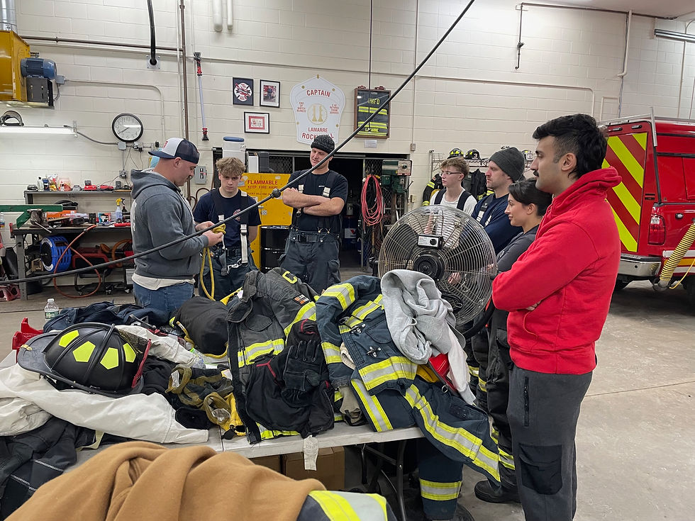 New recruits to the Rocky Hill Volunteer Fire Department familiarize themselves with various types of equipment during a weekly drill. (Mark Jahne)