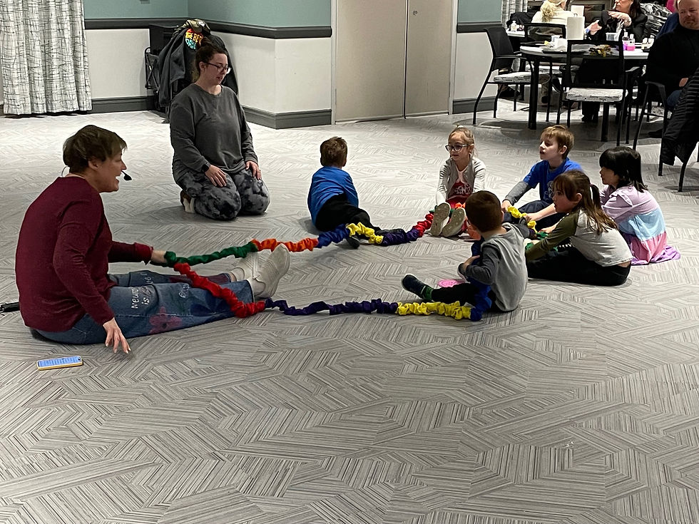 Children enjoy a play activity on the floor.