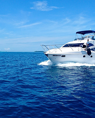 white and blue yacht on sea under blue sky during daytime_edited.jpg