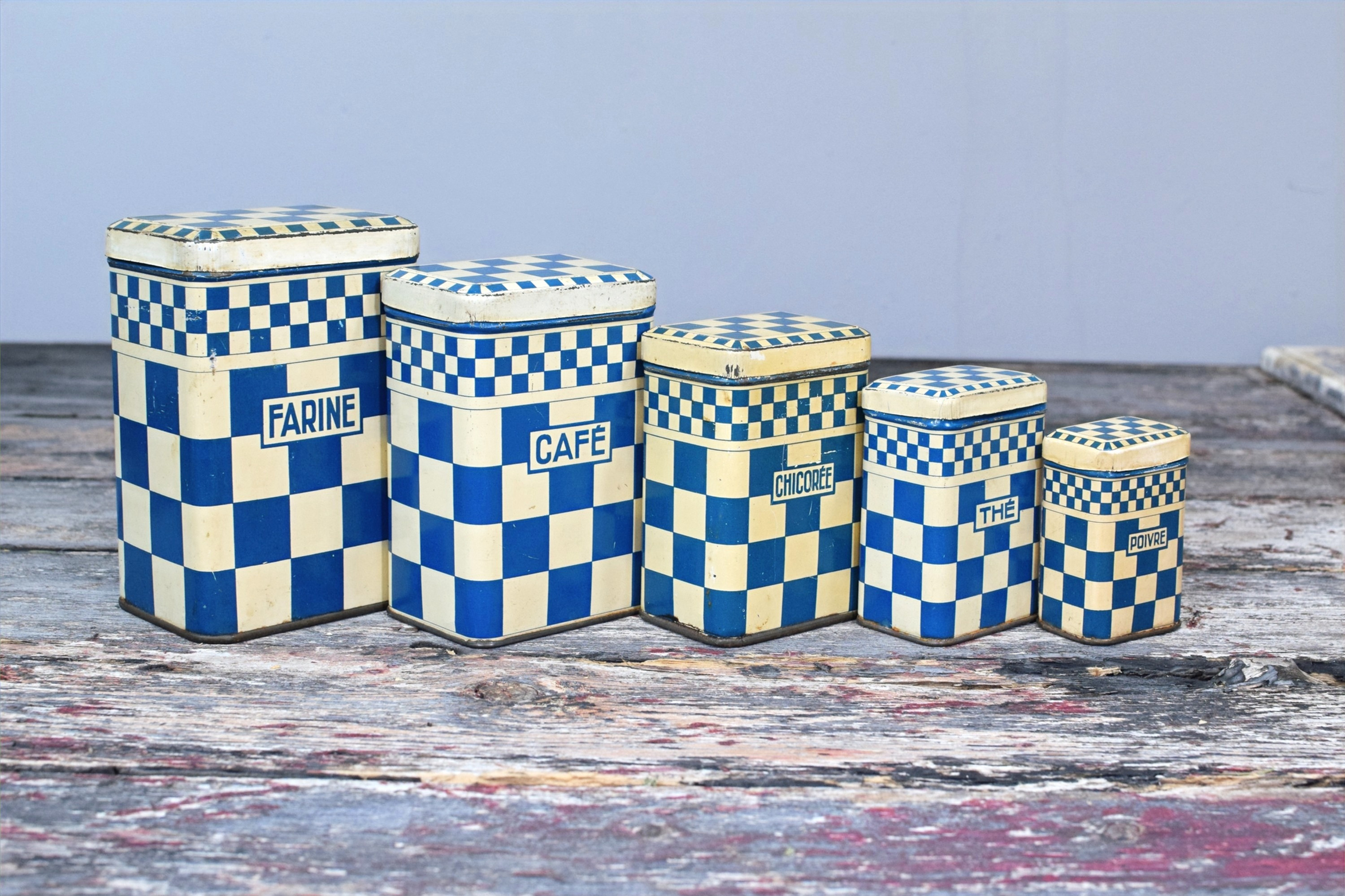 5 blue and white storage tins together