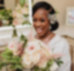 Bride Morayo smiling with bouquet during bridal prep
