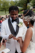 Groom placing ring on bride finger during ceremony