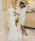 Bride Morayo holding wedding dress during getting ready