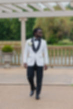 Groom Michael walking outdoors at the wedding venue