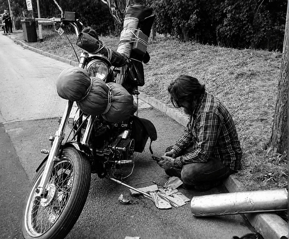 Stephen Smith sitting by his loaded custom harley davidson