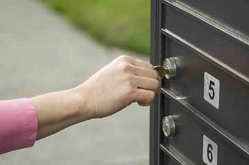 woman opening a mailbox lock