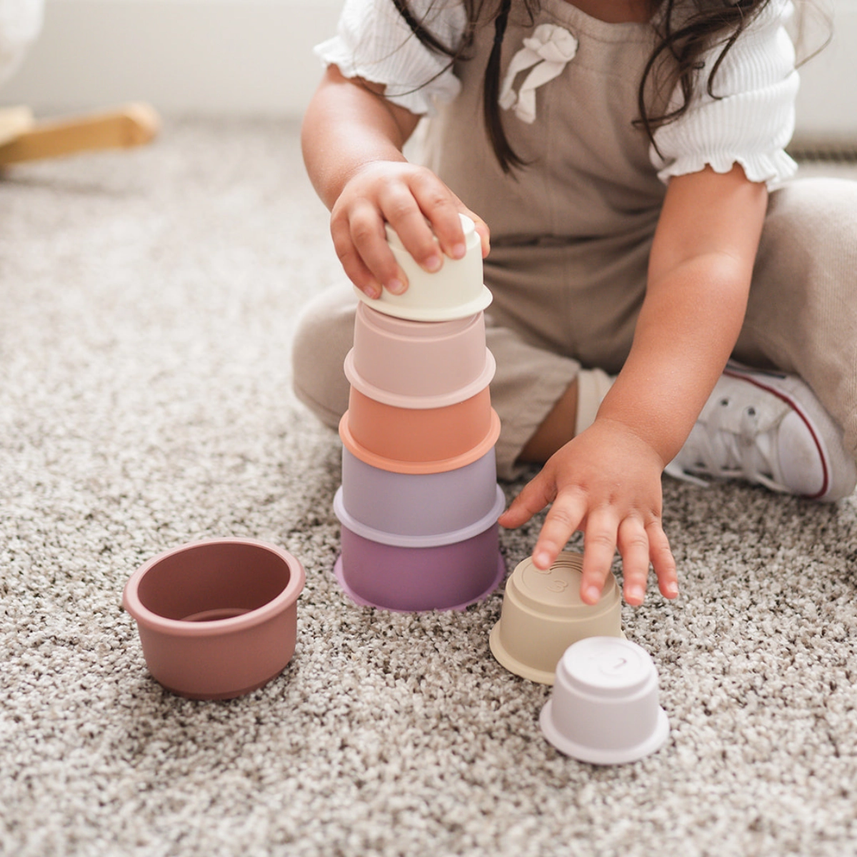 baby playing with stacking cups