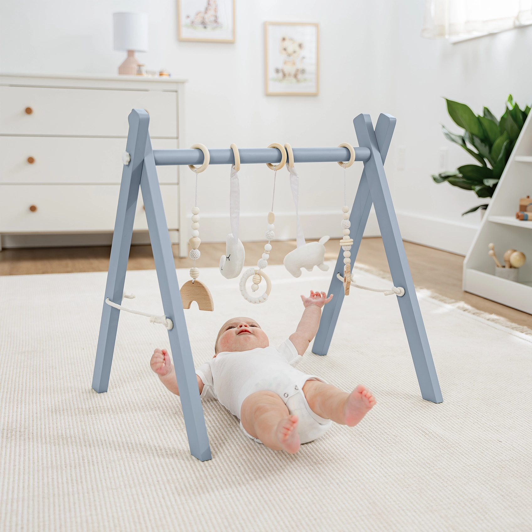 baby playing with play gym