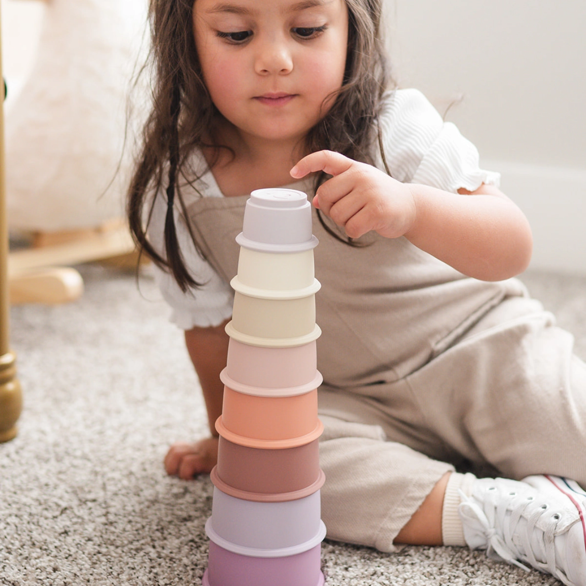 toddler with stacking cups
