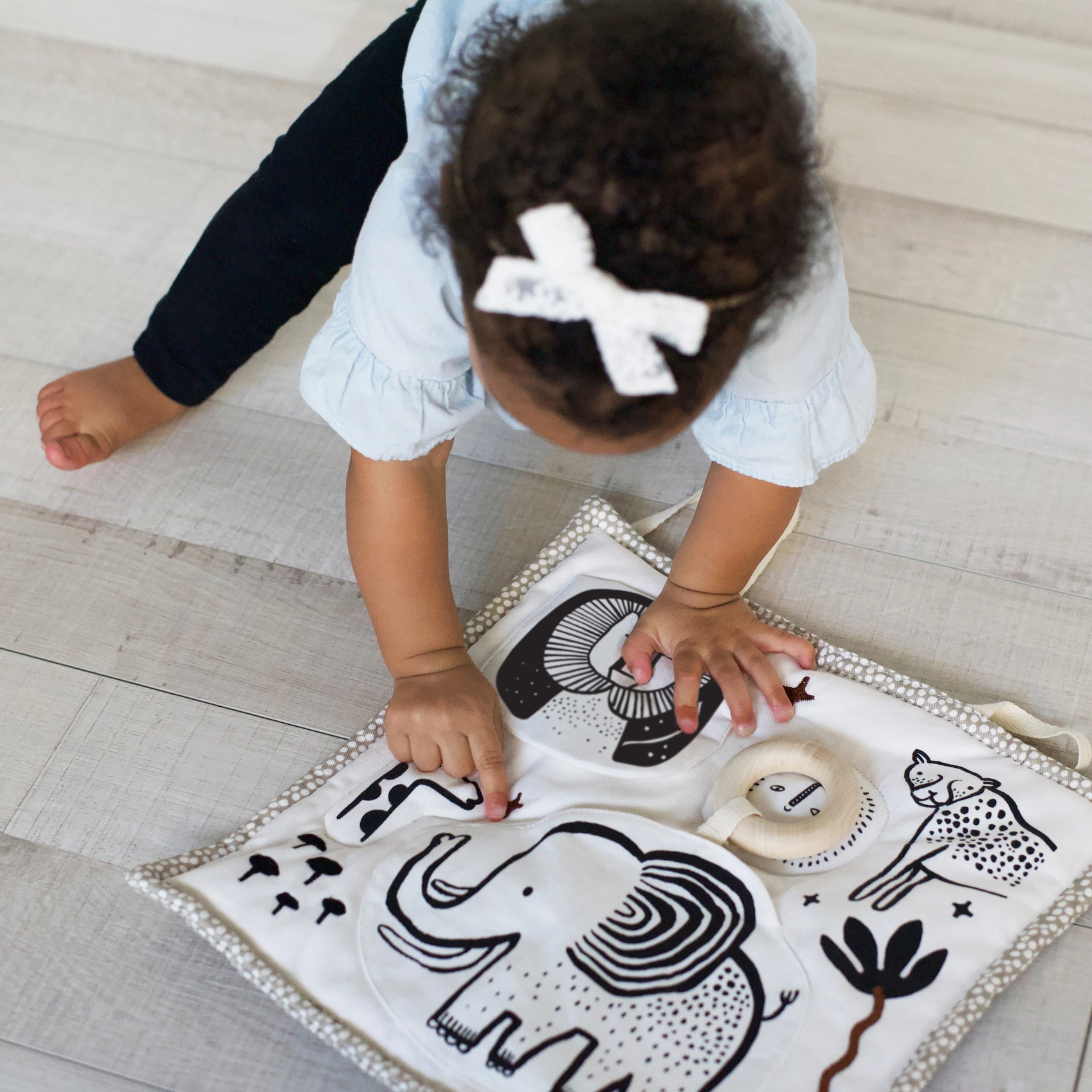 baby playing with sensory mat