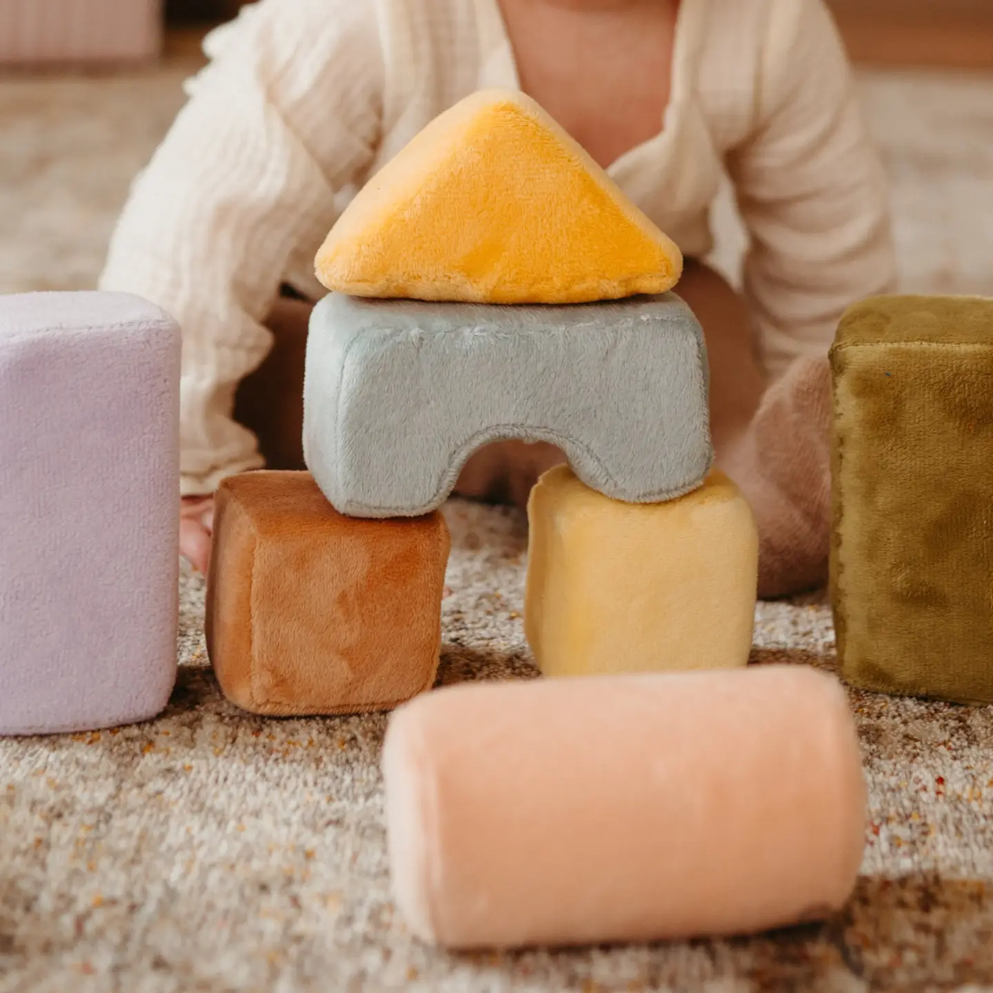 baby playing with stacking blocks
