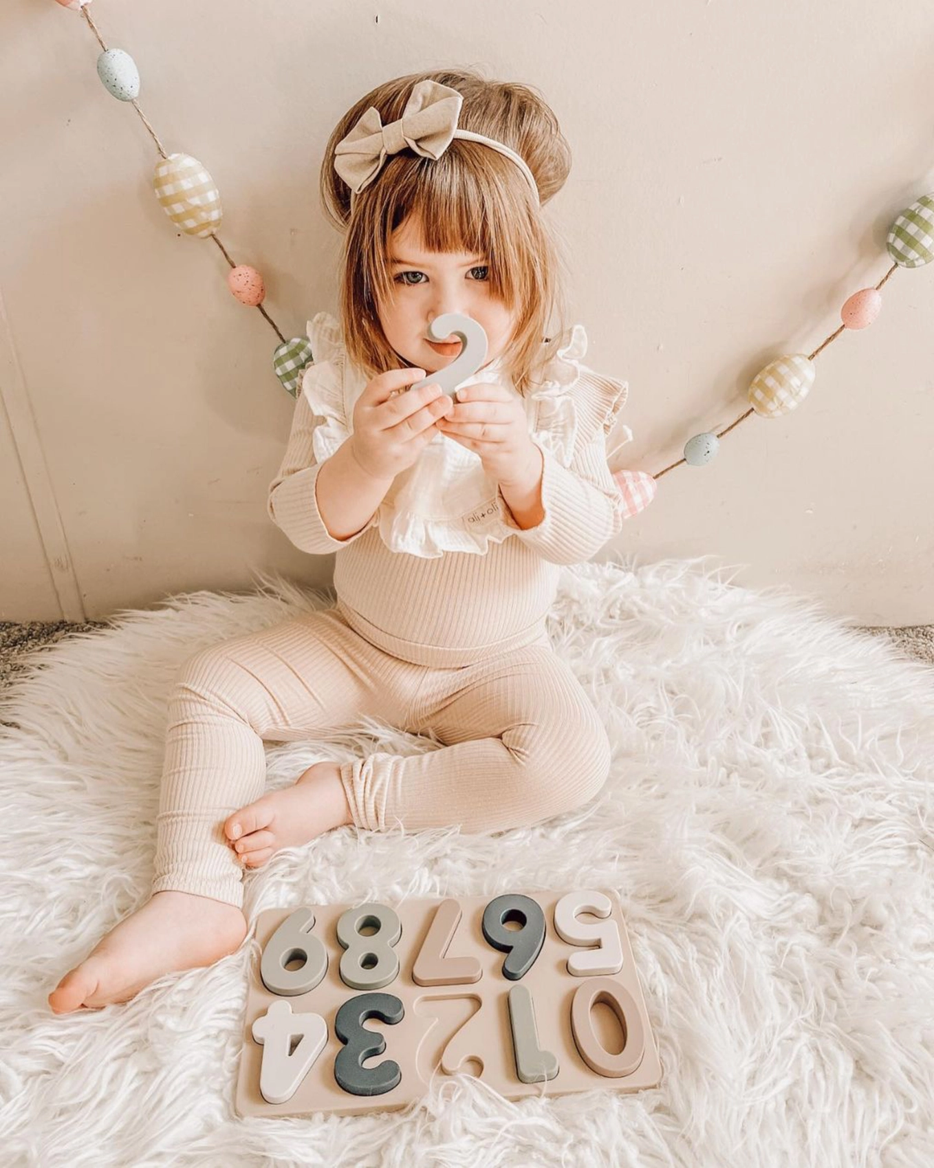 toddler playing with  numbers puzzle