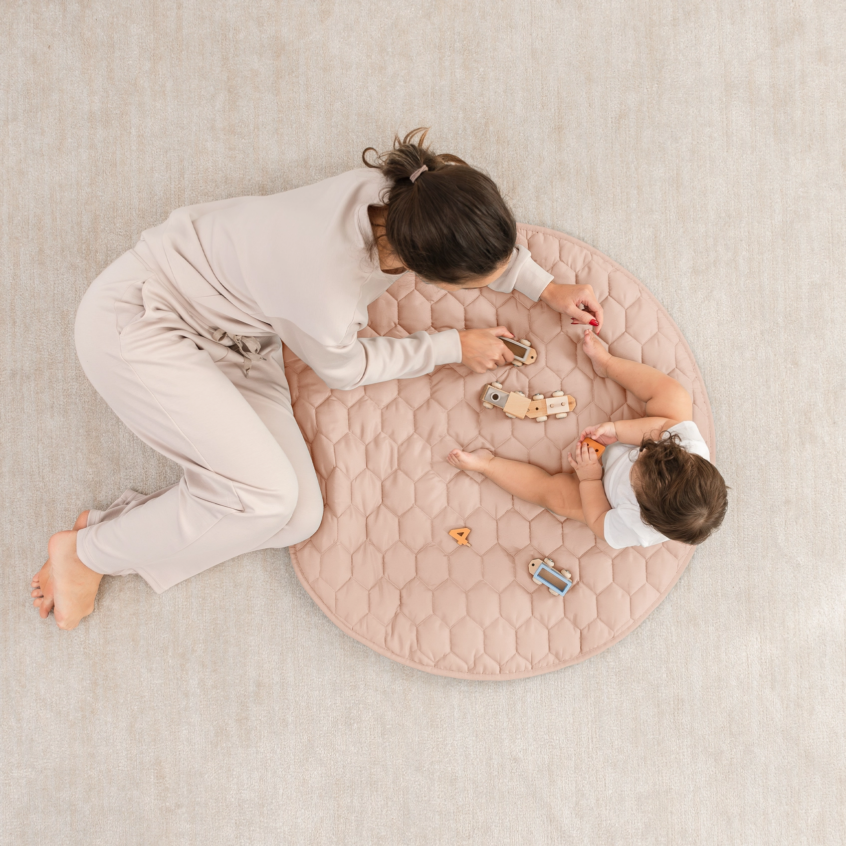 mommy playing with baby on mat
