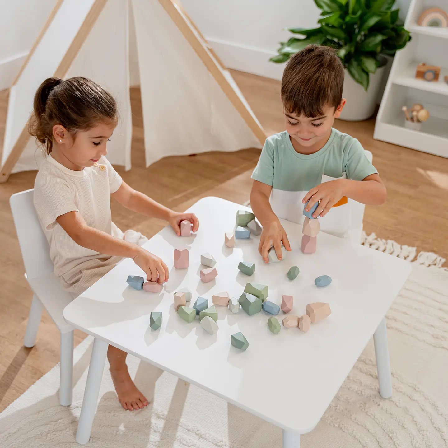 toddlers playing with stacking blocks
