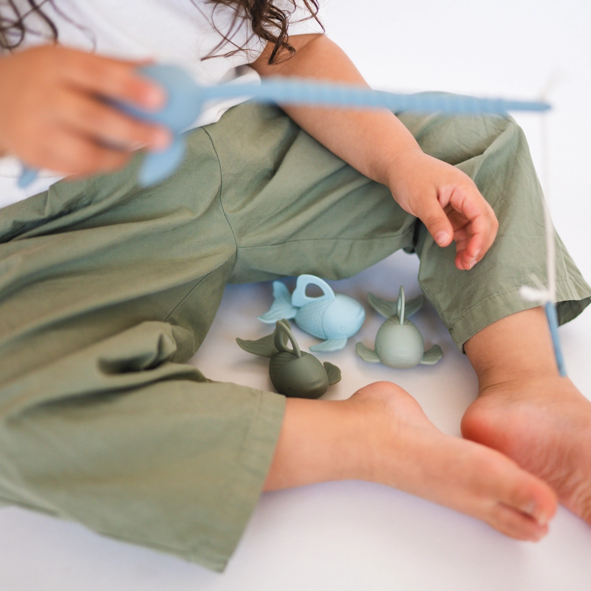 toddler playing with fishing set