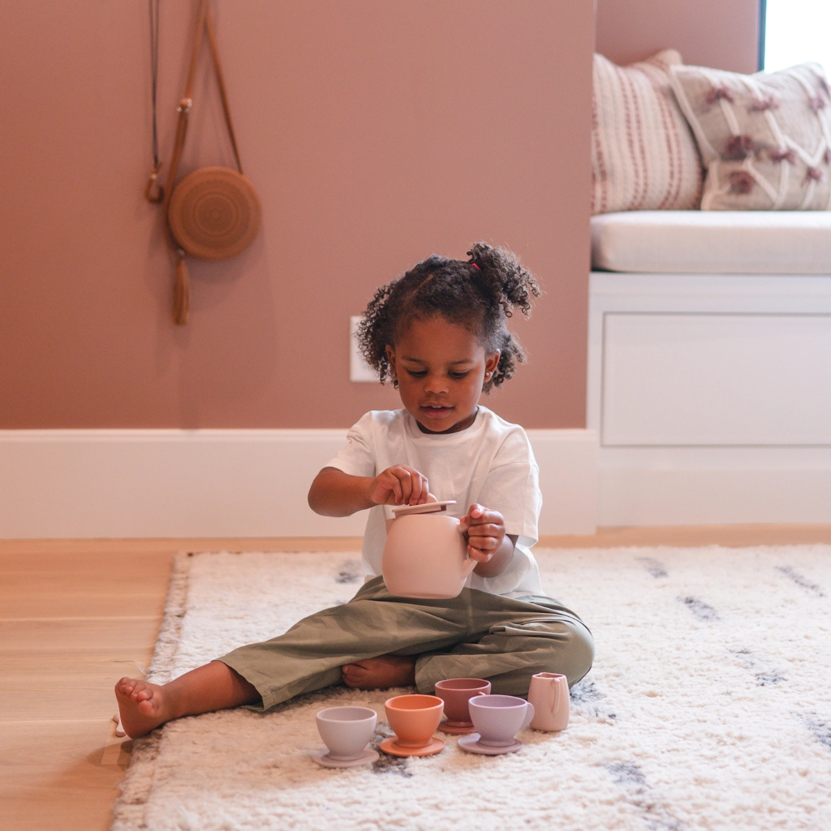 girl playing with tea set