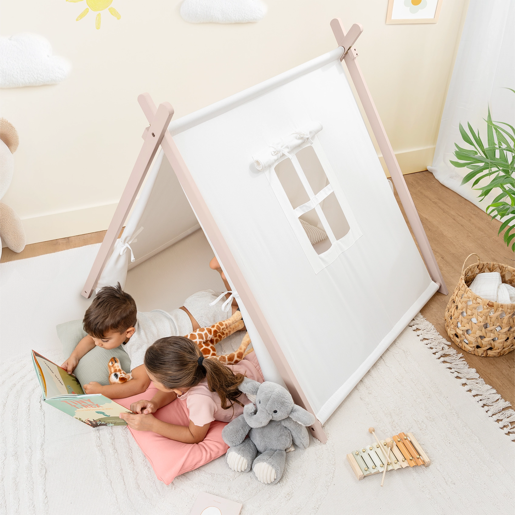 kids reading a book in a tent
