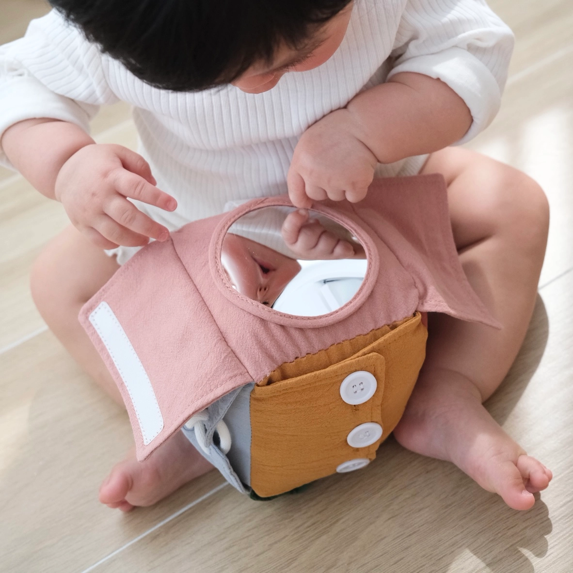 baby looking at sensory cube