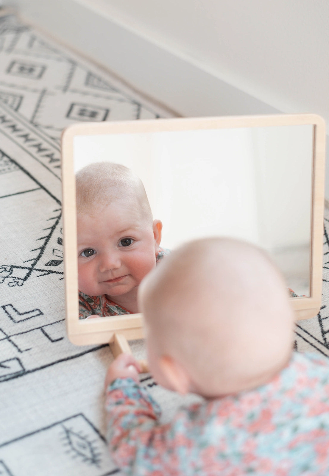 baby looking in mirror