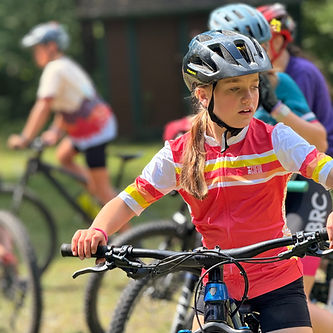 Young rider in a helmet and red jersey during CNY West fall program practice.