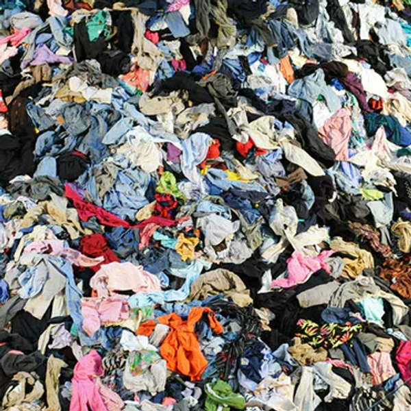 Piles of discarded clothing in a landfill