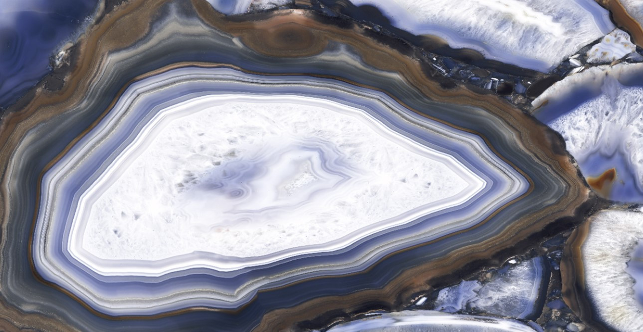 Agata blue stone slab featuring geode like crystal with a blue background