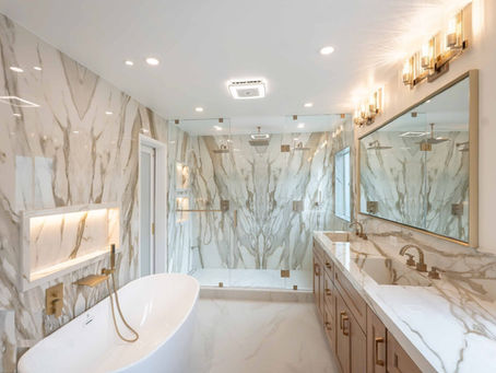 Calacatta Gold Porcelain Slabs Installed Around Shower Walls, Bathroom Countertop And Integrated Sinks Showing Book Matching Slabs That Minimize And Hide Seams