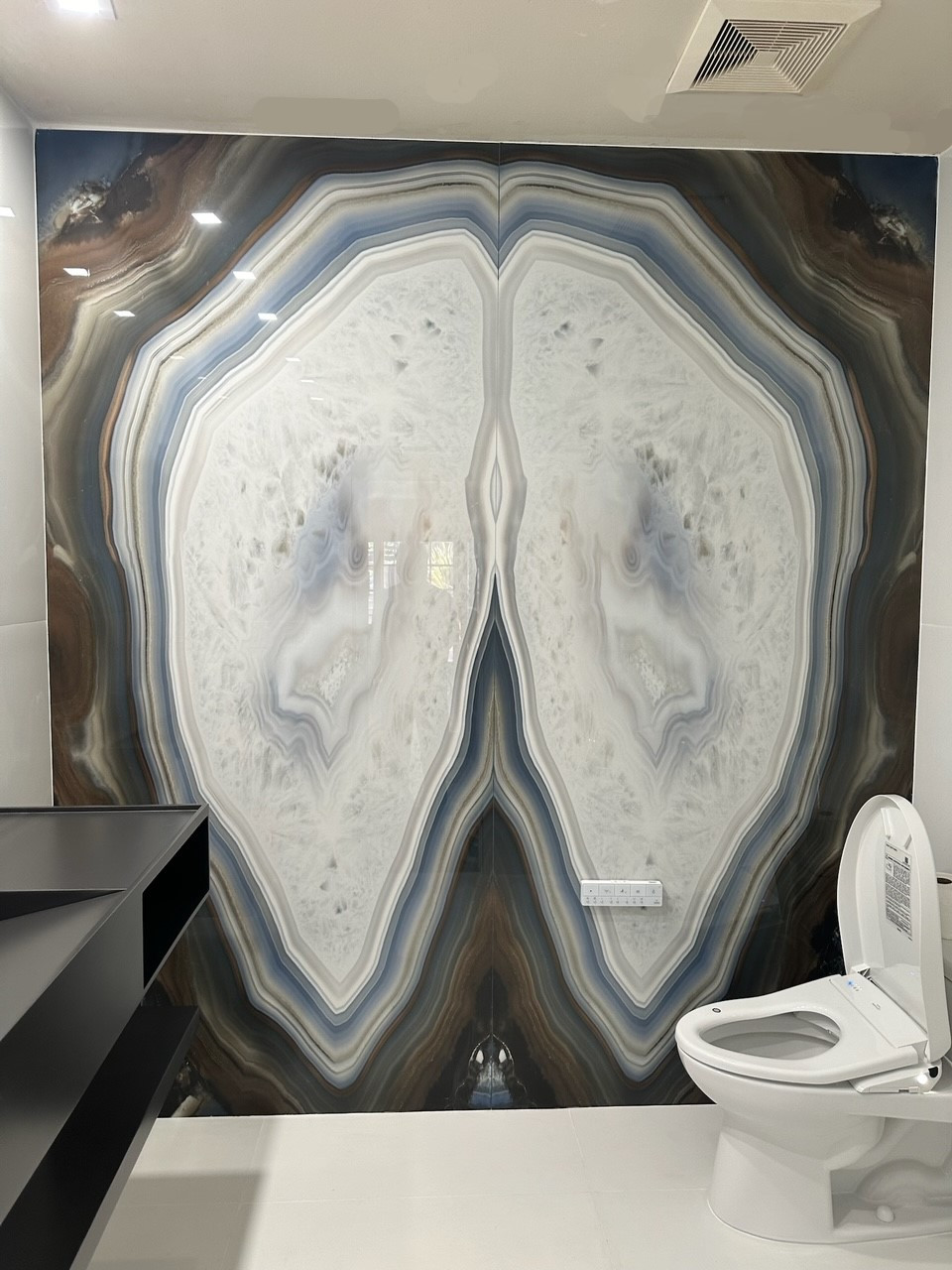 Agata blue stone slab featuring geode like crystal with a blue background