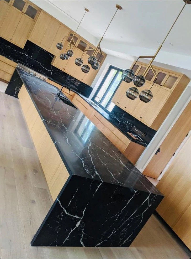 Thumbnail: Large mid century white oak kitchen with black quartz tops that recreate the look of black calacatta marquina marble