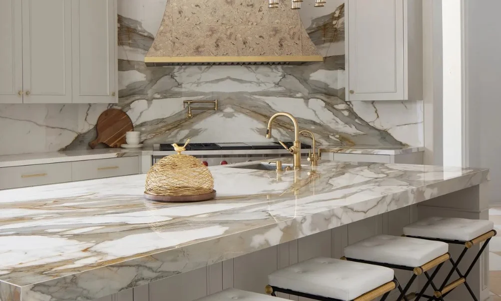 Macchia Vecchia porcelain slab featured on large kitchen island and behind the stove as a full backsplash made of stone