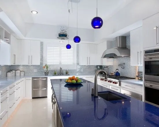 a daylight it kithcen with a nice blue countertop, embedded in crystals, gi.ving the countertop a nice sparkle