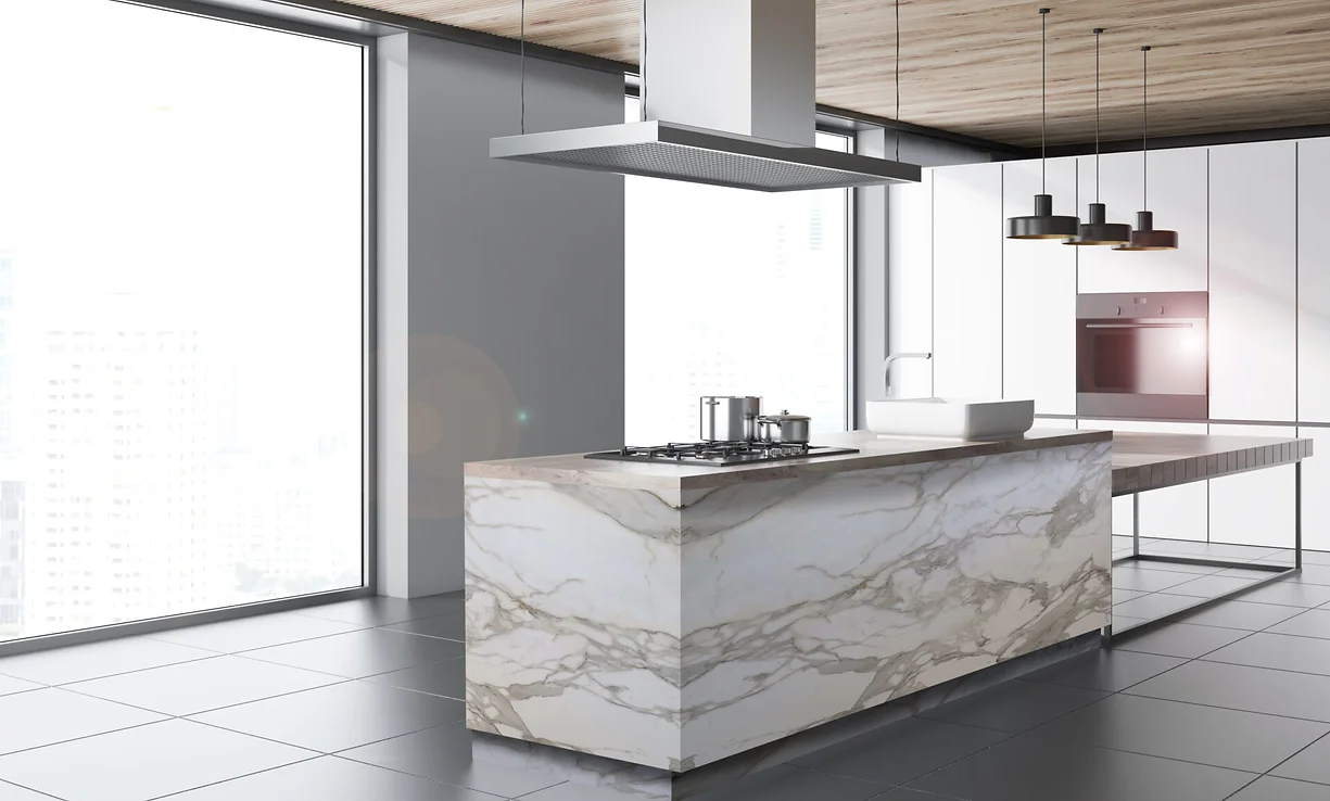 A modern kitchen featuring a stunning Borghini Luxe porcelain slab island with elegant waterfall edges. The slab showcases a crisp white background with bold, flowing gray and gold veining, adding a touch of luxury. The sleek cabinetry, minimalist design, and high-end appliances complement the sophisticated aesthetic, creating a refined and contemporary space.