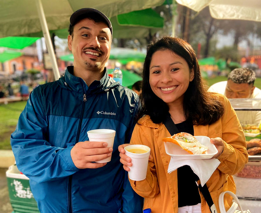 Travelers sample delicious local snacks along a lively Guatemalan street food street, surrounded by tempting food stalls and so many traditional flavors that choosing what to try next becomes part of the fun.