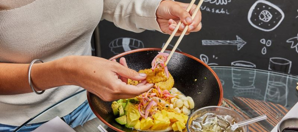 Woman eating Ceviche at Sushiato