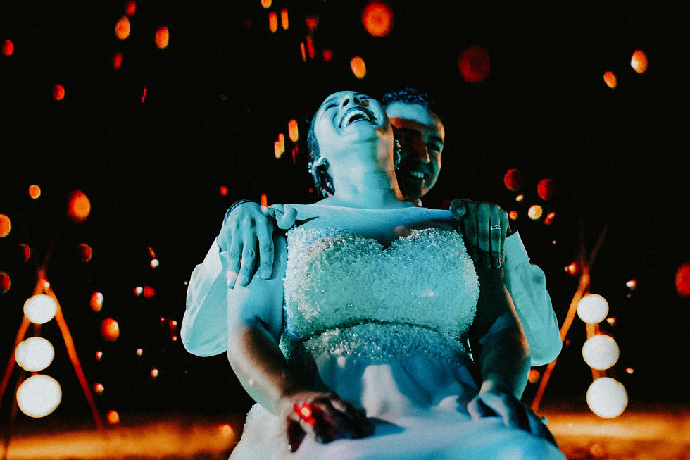 8-Joyful bride laughing with groom from behind, surrounded by warm bokeh lights.jpg